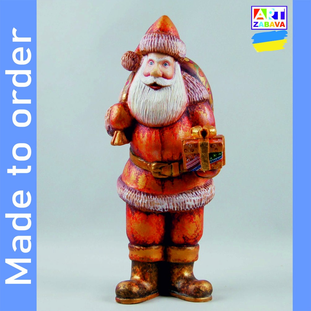 9.25-inch custom order hand-carved and painted Santa Claus wooden figurine with gift and bag, featuring detailed craftsmanship and Christmas design.