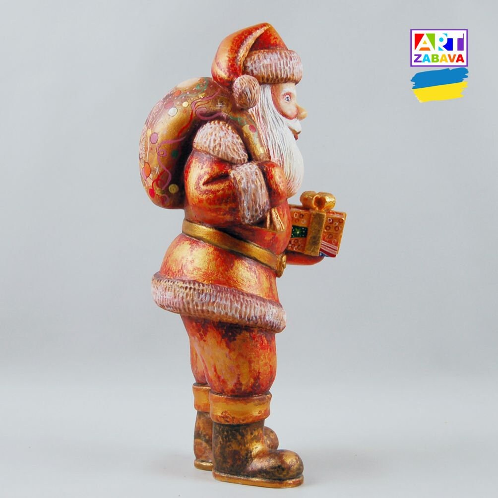 9.25-inch custom order hand-carved and painted Santa Claus wooden figurine with gift and bag, featuring detailed craftsmanship and Christmas design.